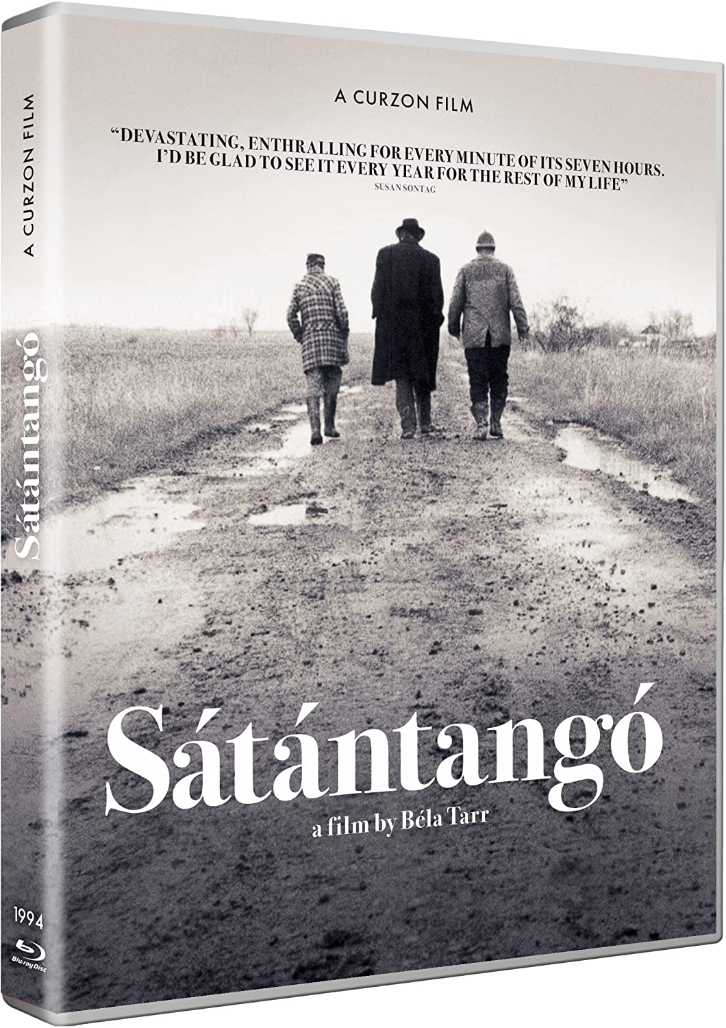 "Sátántangó Blu-ray case with a black and white image of three men walking."