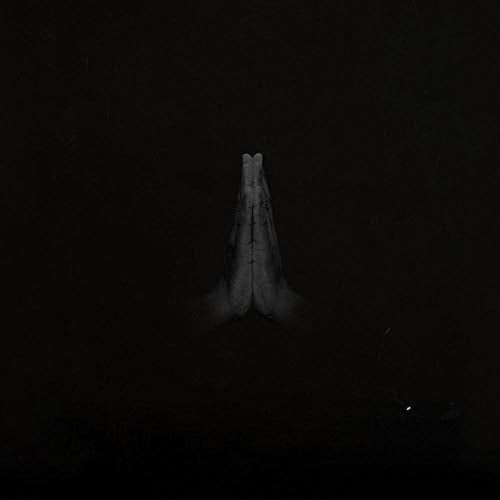 Two hands pressed together in prayer against a solid black background.