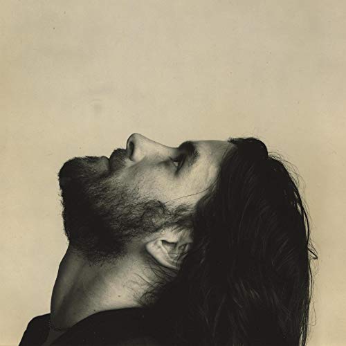 Black and white portrait of a man looking upwards, with beard and long hair.