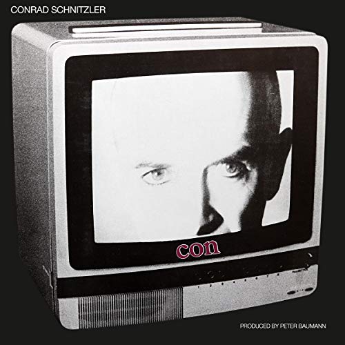 "Vintage television displaying a black and white man's face, on a black background."