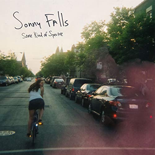 CD cover: street scene with a person on a bicycle, trees.