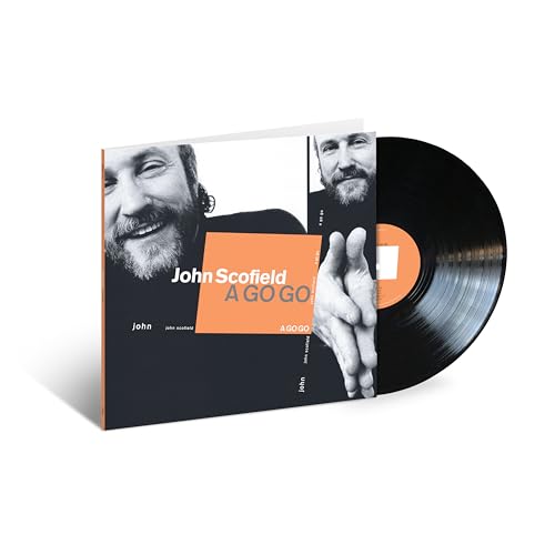 Black vinyl record and cover with orange accents and black and white musician photos.