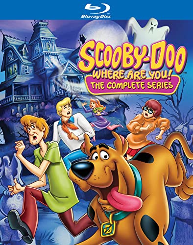 Scooby-Doo characters running from a ghost in front of a haunted house.