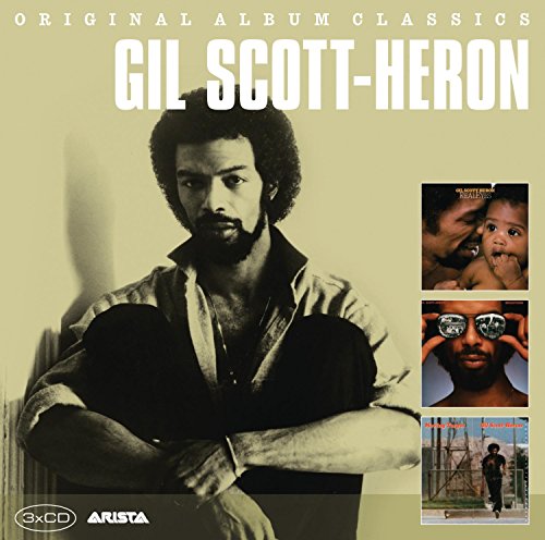 Gil Scott-Heron sitting with arms crossed on a yellow background with smaller album covers.