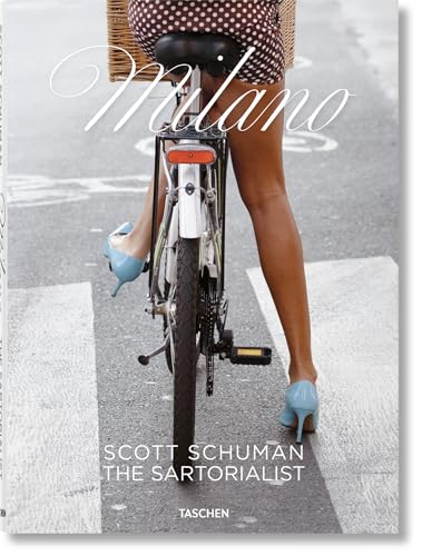 A woman in a polka-dot dress and blue heels riding a bicycle in Milan.