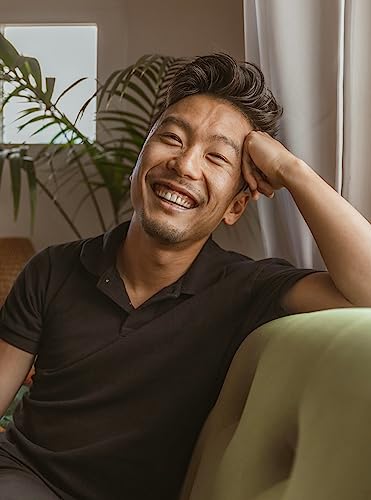 Book cover with a smiling Asian man resting his head on his hand.