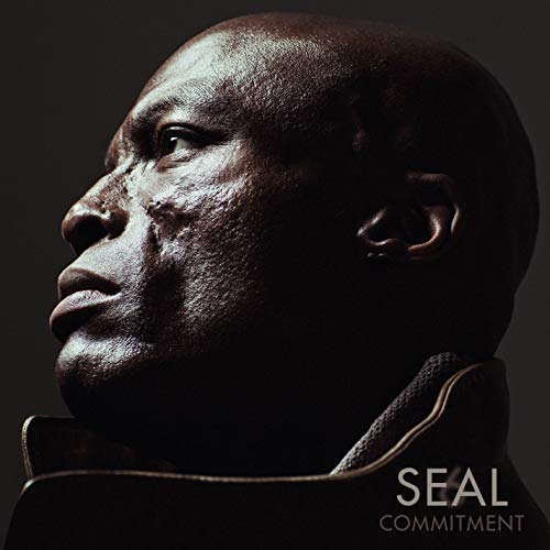 Close-up profile portrait of singer Seal against a dark background with album text below.