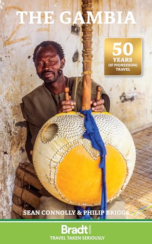 A man holds a kora instrument on the cover of The Gambia travel guide.