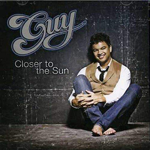 CD cover featuring Guy Sebastian, smiling and crouching, with album title.