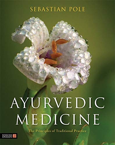 Book cover: “Ayurvedic Medicine” with a close-up of a white flower.