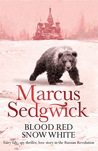 A brown bear walks across a snowy landscape with a Russian cathedral in background.