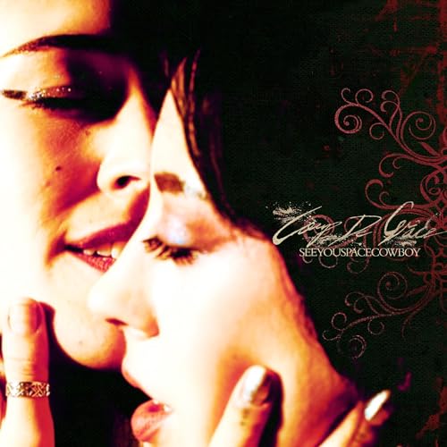 CD cover: two faces in profile with ornate, dark floral design.