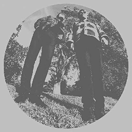 Black and white photo of three figures in a wooded area.