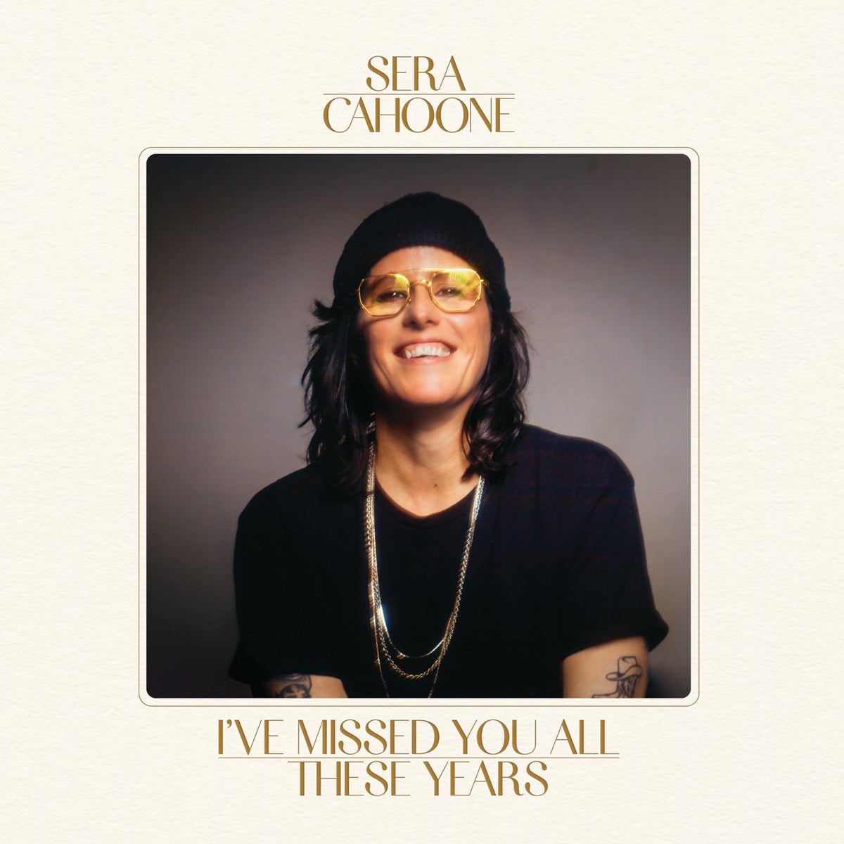 Sera Cahoone wearing a beanie and yellow-tinted glasses on a music album cover.