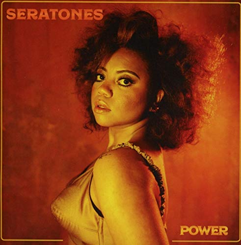 Album cover featuring a woman with curly hair against a warm, orange-toned background.