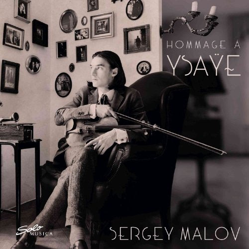 Black and white album cover with a man holding a violin, surrounded by framed photos.