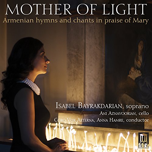 A woman in profile looks toward a religious painting behind lit candles in a church.