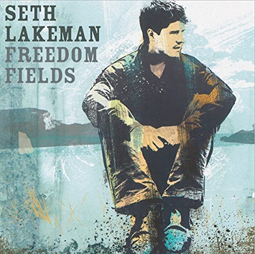 Seth Lakeman sits in a stylized, blue-toned landscape on the Freedom Fields album cover.