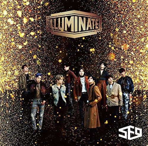 Group of seven men in stylish clothes against a gold glitter background.