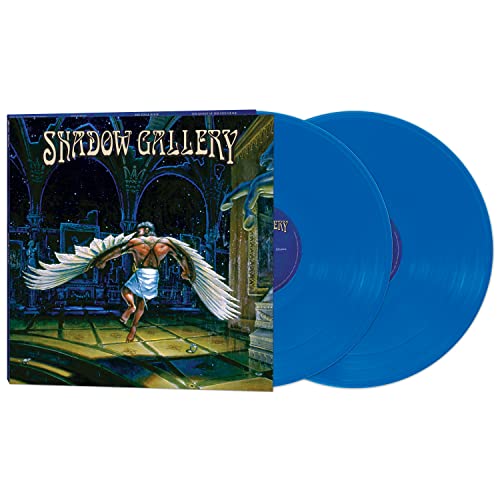 Blue vinyl records next to an album cover featuring a winged man.