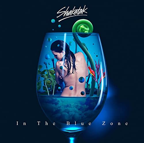 CD cover: woman submerged in blue liquid inside a wine glass.