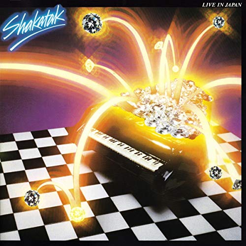 Shakatak album cover: piano with glowing arcs and diamond-like shapes.