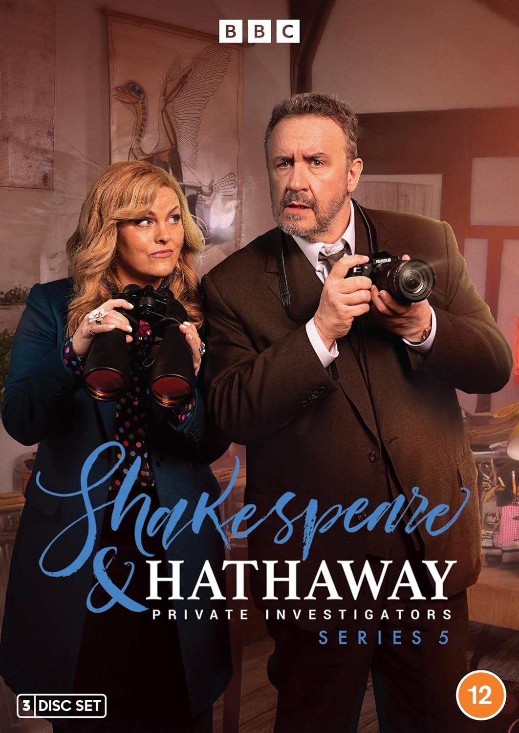 Two private investigators holding binoculars and a camera on a Shakespeare and Hathaway DVD cover.
