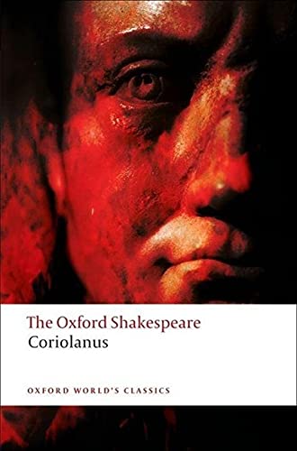 Book cover of "Coriolanus" with a close-up of a man’s face in red tones.