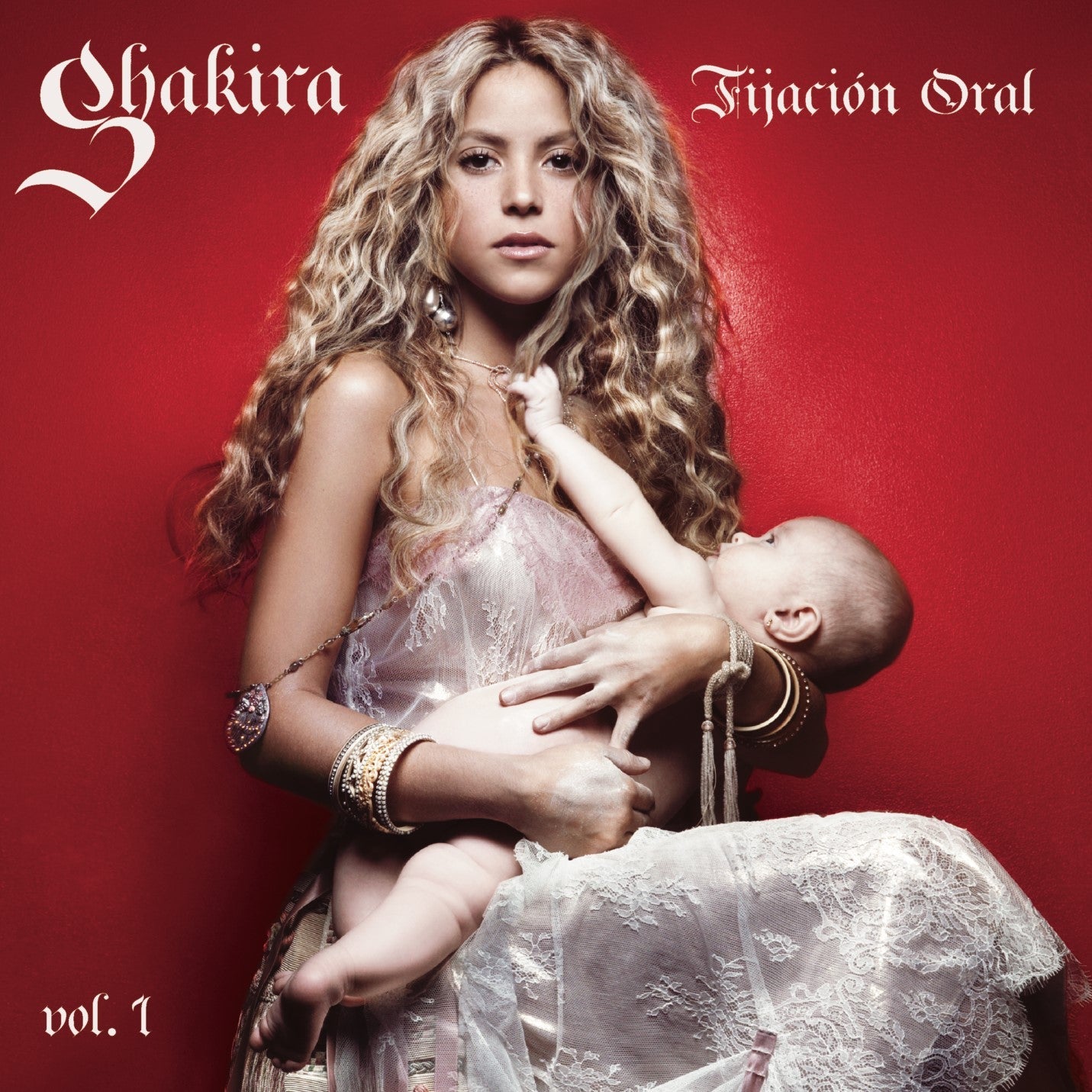 Shakira holding a baby on a red background, album cover art.