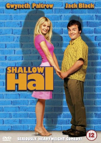 Gwyneth Paltrow and Jack Black holding hands against a blue brick wall background.