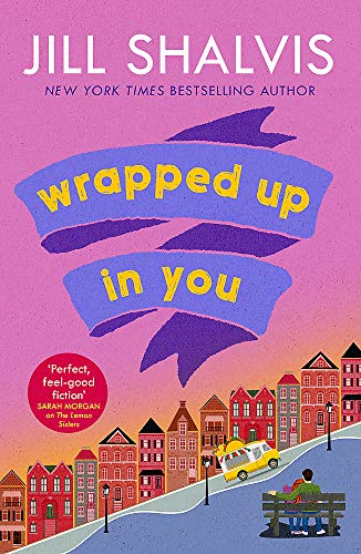 Book cover with pink background, purple ribbon title, and a couple sitting on bench.