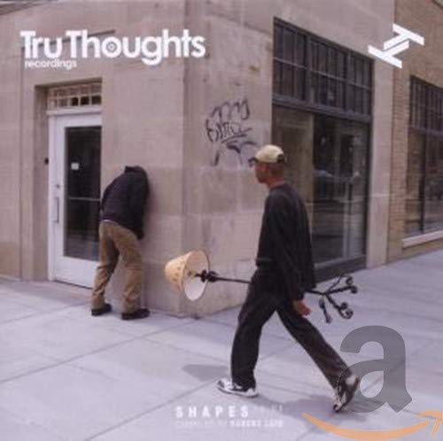 CD cover: two men with a strange contraption in front of a building.