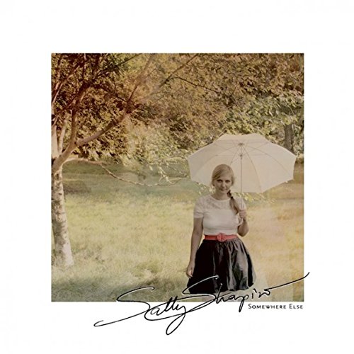 The album cover for "Somewhere Else" by Sally Shapiro features a woman holding a white umbrella.