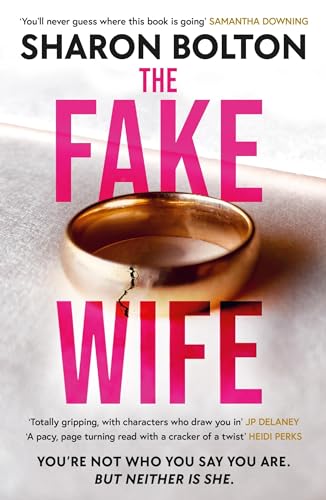 Book cover: "The Fake Wife" with a broken gold wedding ring.