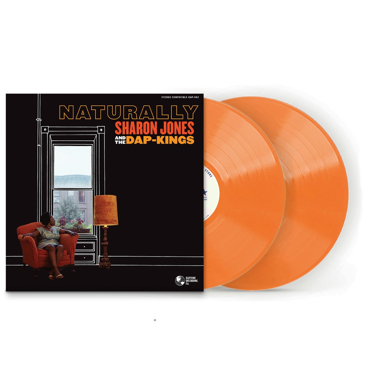 Sharon Jones sits in an orange armchair near a window with a floor lamp.