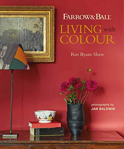 Book cover with red wall, flowers, lamp, and framed artwork.