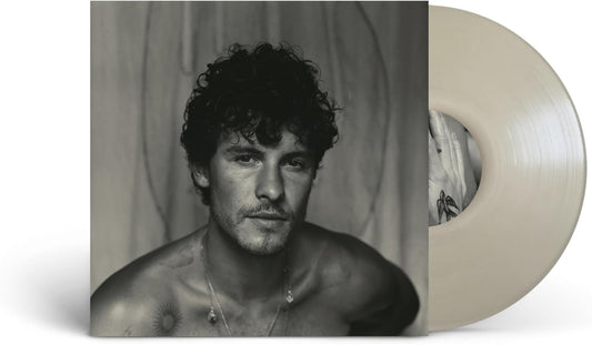 Black and white portrait of Shawn Mendes with a vinyl record.