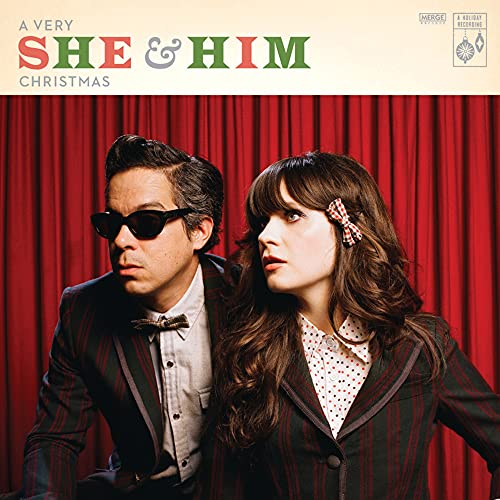 She & Him Christmas CD cover featuring a man and woman in suits.