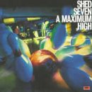 Album cover for Shed Seven's A Maximum High featuring blurred, colorful, floating orbs.