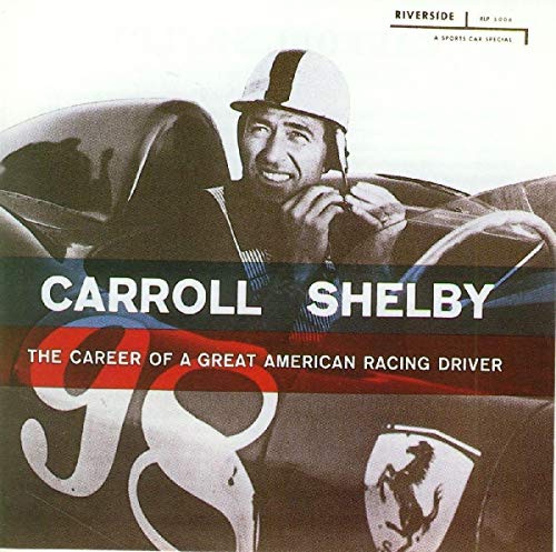 Carroll Shelby in racing helmet, leaning into a sports car cockpit.