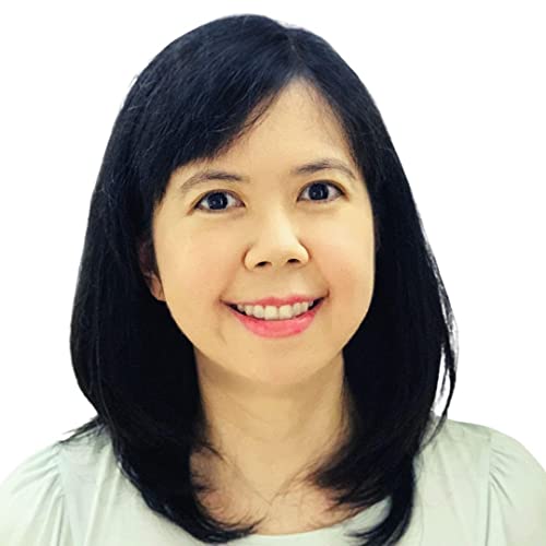 A smiling woman with shoulder-length black hair wearing a light-colored top.