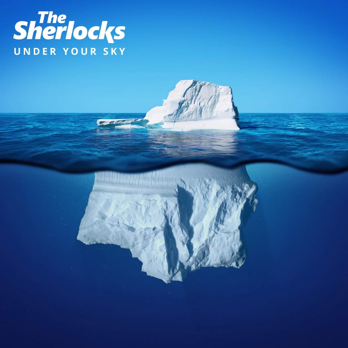 CD cover with iceberg partially submerged in ocean, "The Sherlocks" and "Under Your Sky" text.