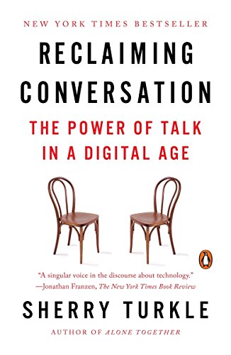 Book cover with bold red title, "Reclaiming Conversation," and two empty chairs.