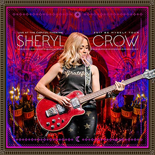 Sheryl Crow playing a red electric guitar on stage, concert album cover.