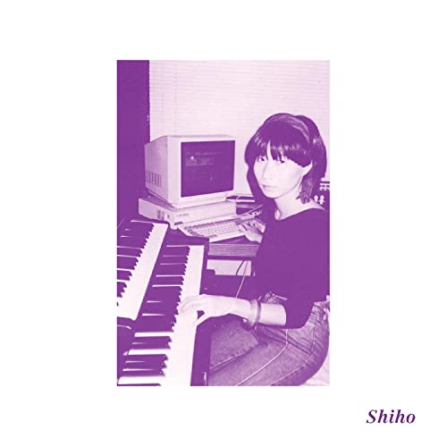 Woman with bob haircut at keyboard and computer, purple tone.