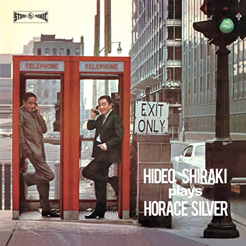 Album cover: two men in suits by a red telephone booth.