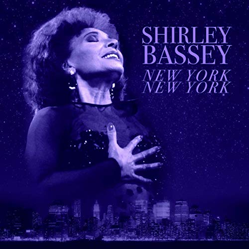 Shirley Bassey album cover with city skyline and starry background.
