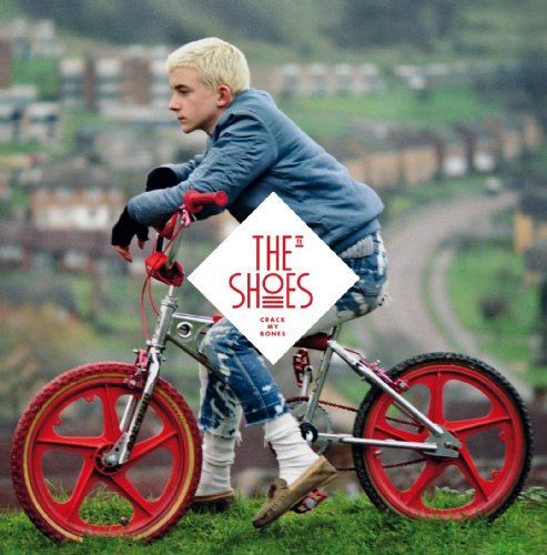 Boy on a red-wheeled bicycle, album cover for "Crack My Bones.