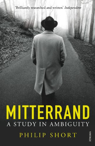 Book cover: man in coat seen from behind, title “Mitterrand.”