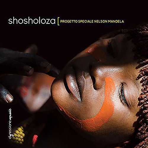 "CD cover with a woman's face and orange cheek paint."